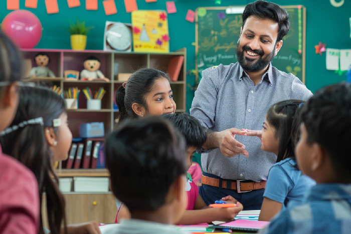A teacher providing personalized instruction to a small group of students.