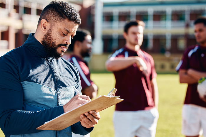 Specialist coach instructing students in a sports academy setting.